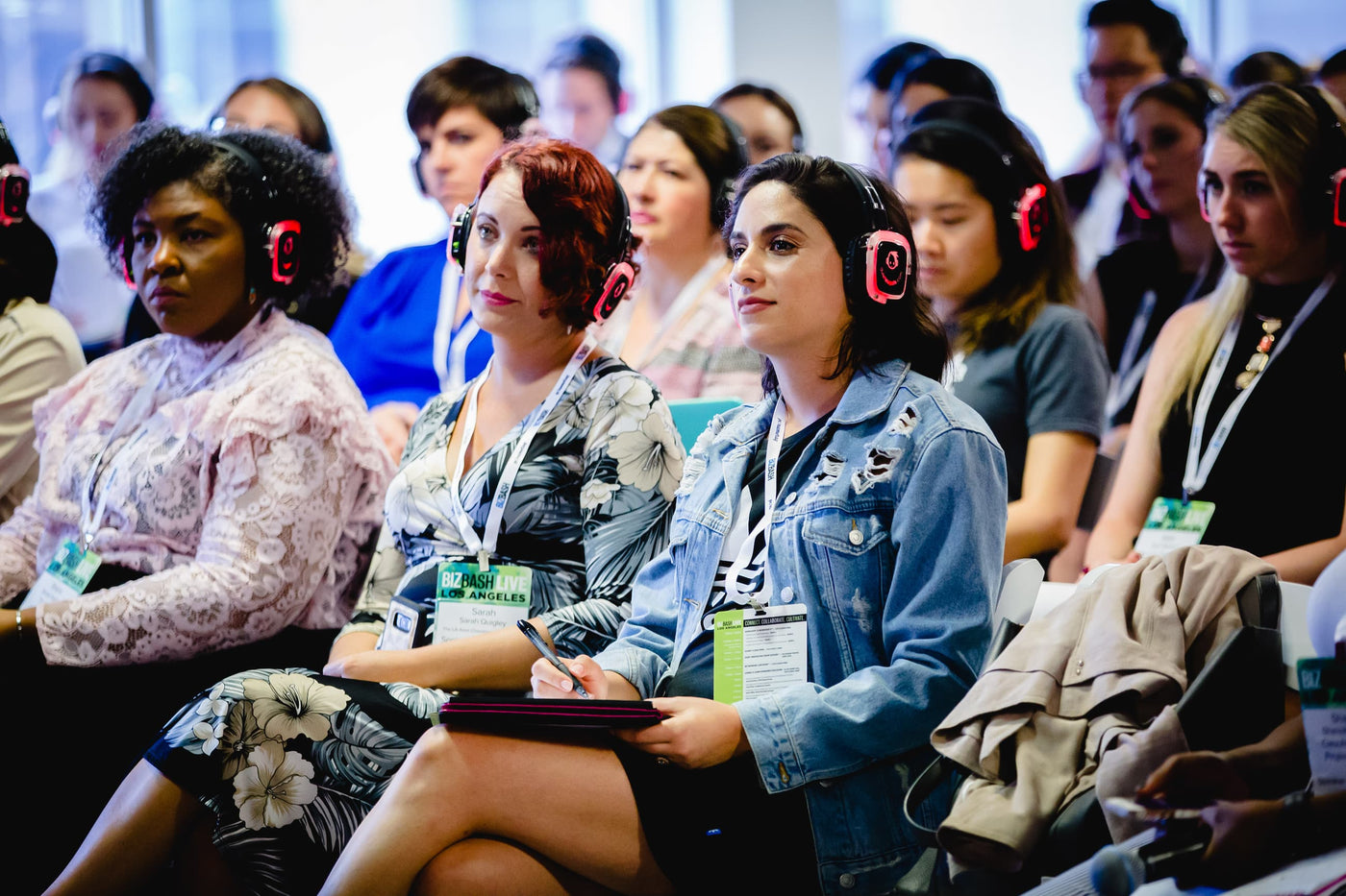 Quiet Events Silent Disco headphones for conferences a group people listening to a speaker.