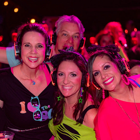 Quiet Events Silent Disco headphones for bar mitzvah. A group of adults together posing for a picture with headphones.
