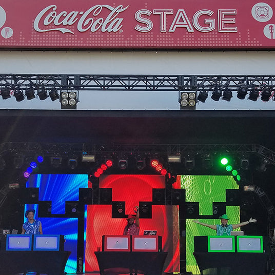 Quiet Events Silent Disco headphones for festivals a group of DJ's on stage in various colors cheering on the crowd.