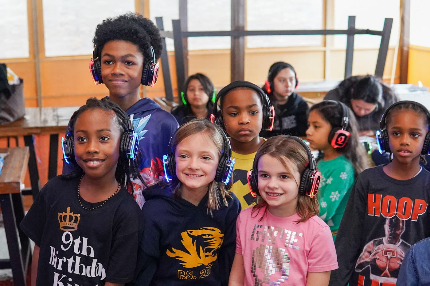 Quiet Events Silent Disco headphones for home with a group of children wearing headphones and posing for a picture.