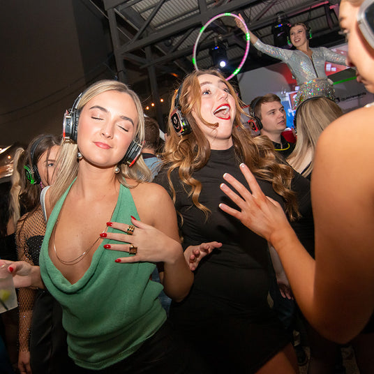 Quiet Events Silent Disco headphones for New York. A group of girls dancing having fun enjoying themselves in a party atmosphere wearing headphones.