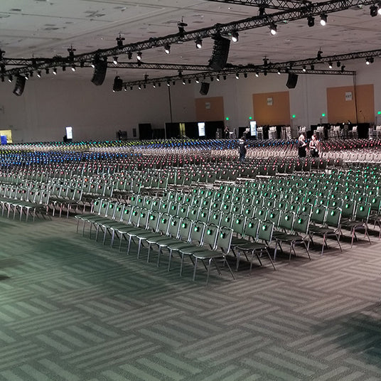 Quiet Events Silent Disco headphones for Corporate gatherings thousands of chairs with silent dsico headphones on them in a confernece hall