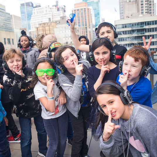 Quiet Events Silent Disco headphones for church.  A group of kids outdoors having fun wearing headphones.