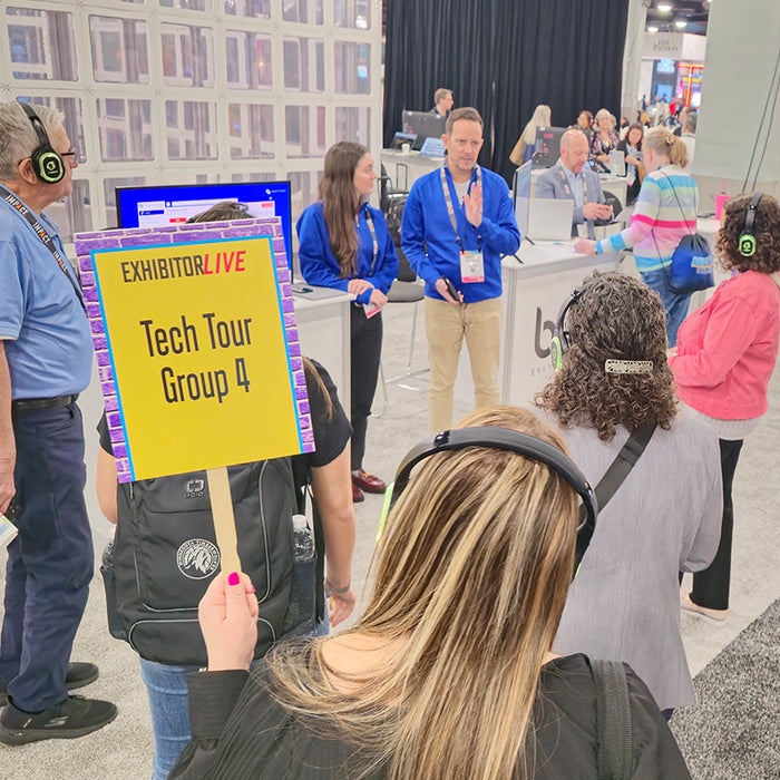 Quiet Events Silent Disco headphones for expo tour a group of people gather listening with headphones to a speaker