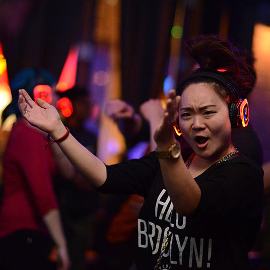 Quiet Events Silent Disco headphones for run walks.  A participant having fun enjoying the moment wearing headphones.