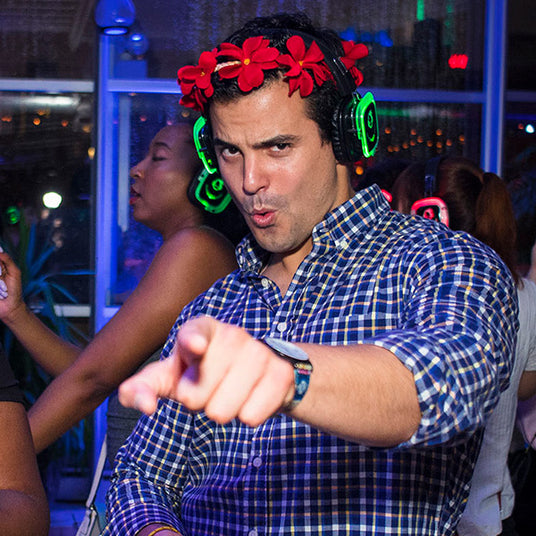Quiet Events Silent Disco headphones for run walks.  A participant having fun wearing headphones and pointing at you.