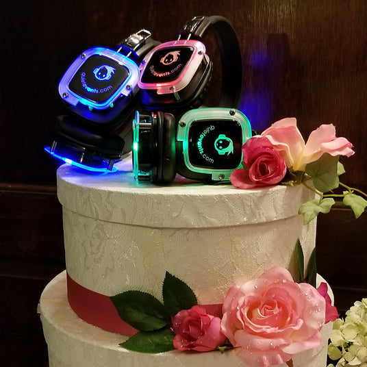 Quiet Events Silent Disco headphones for wedding.  A picture of a two level cake with headphones as the center piece.